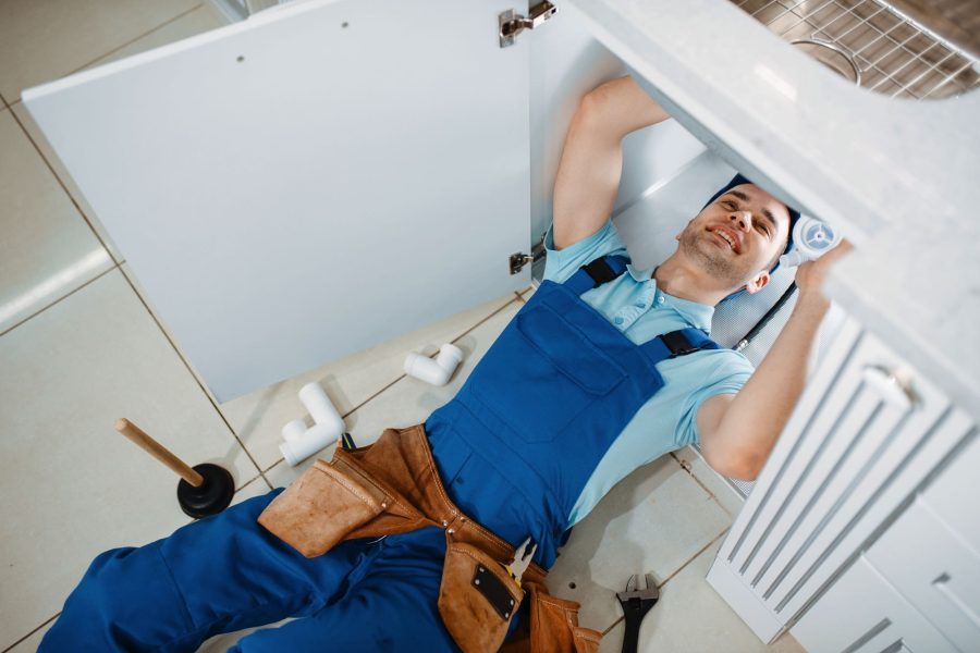 plumber-in-uniform-installing-drain-pipe-top-view-GKUZZ9Q-1-prtlsyjxx42lde3ec4dyswr88jn5ei3slff24ehx80